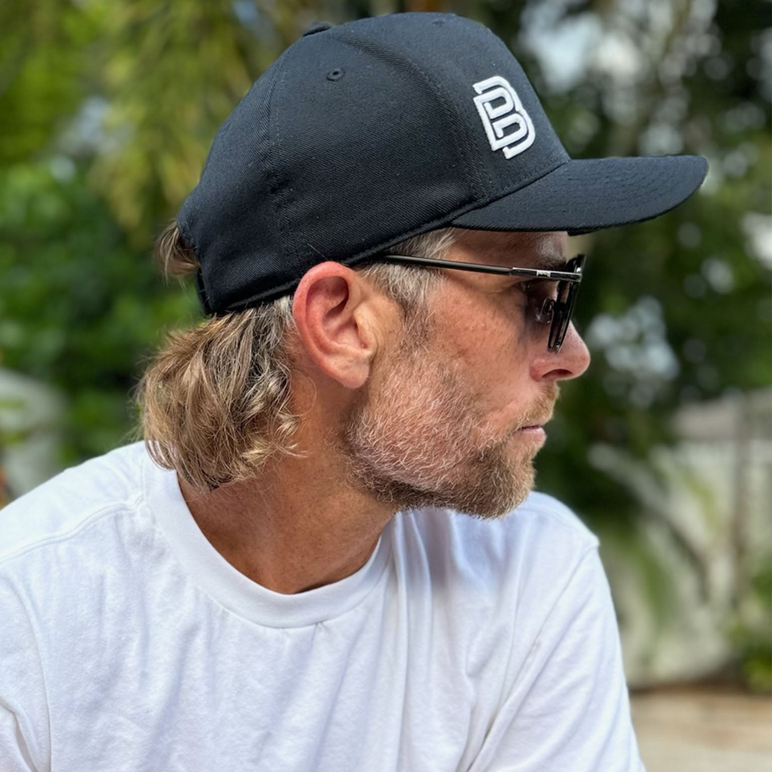 Travis-Rettenmaier-wearing-a-Baseline-Boss-Peak-Hat-in-Navy