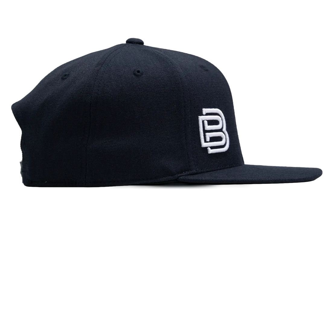 Baseline Boss Bandit navy pickleball hat left profile. Snapback design with side panel and logo visible.