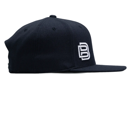 Baseline Boss Bandit navy pickleball hat left profile. Snapback design with side panel and logo visible.